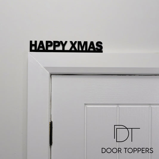 HAPPY XMAS acrylic sign displayed above a door, a modern Christmas decoration handmade in the UK.
