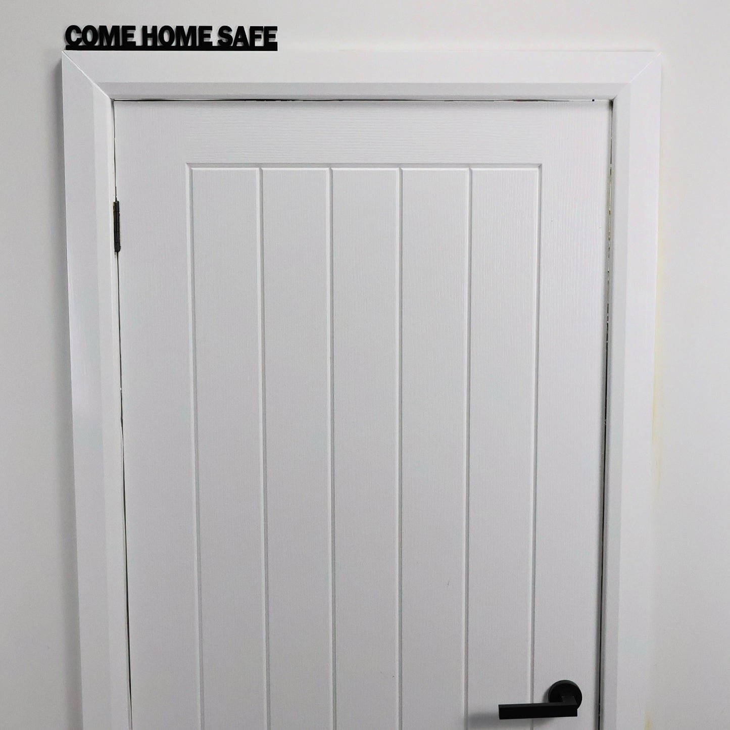 Hallway view showing COME HOME SAFE sign above entrance