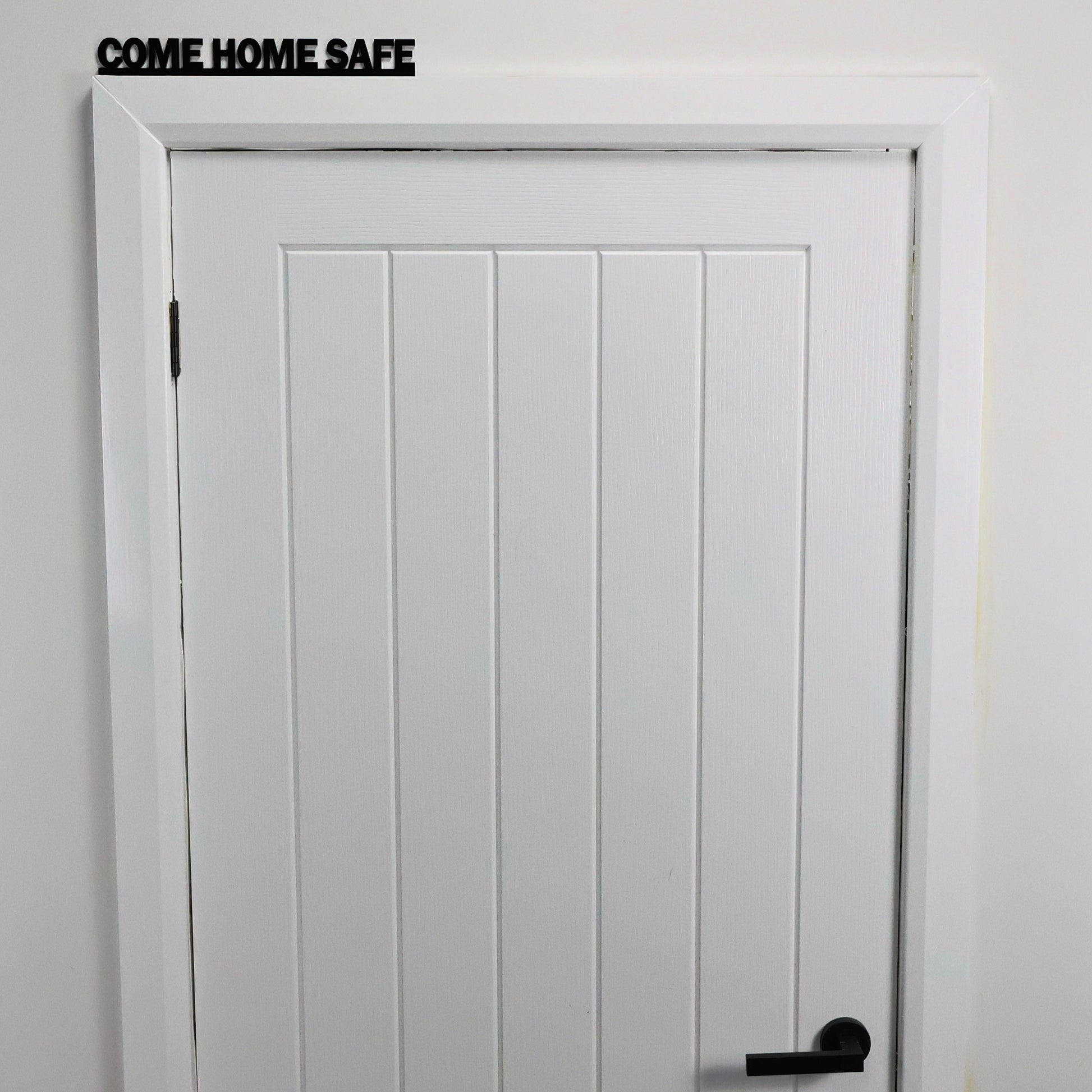 Hallway view showing COME HOME SAFE sign above entrance