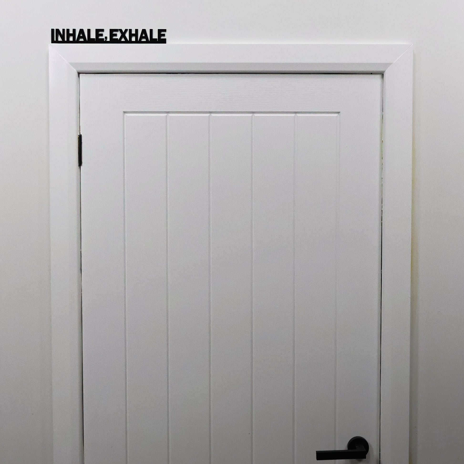 Mindfulness quote door topper shown from a distance on a white door frame