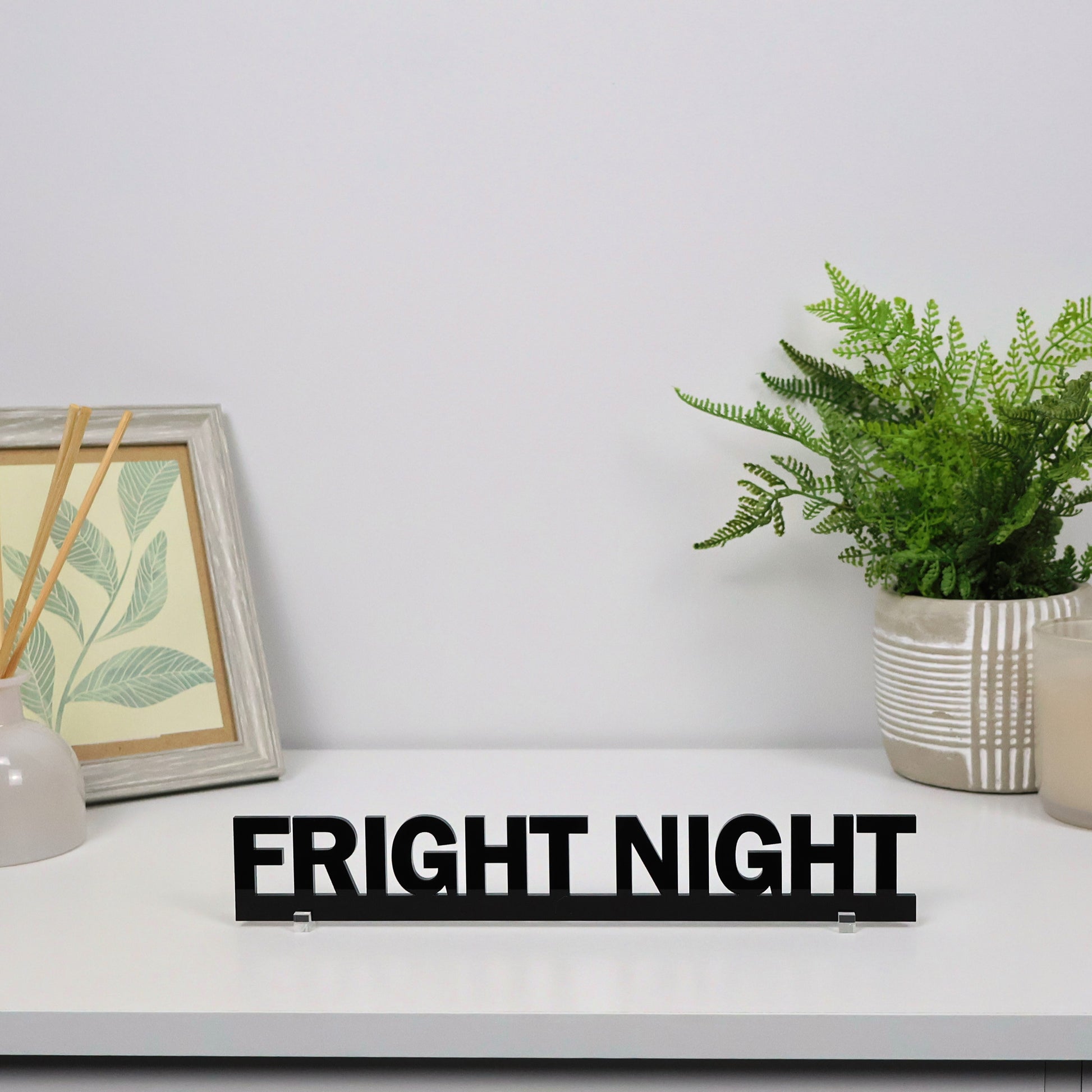 FRIGHT NIGHT sign shown freestanding on a shelf beside candles and pumpkins