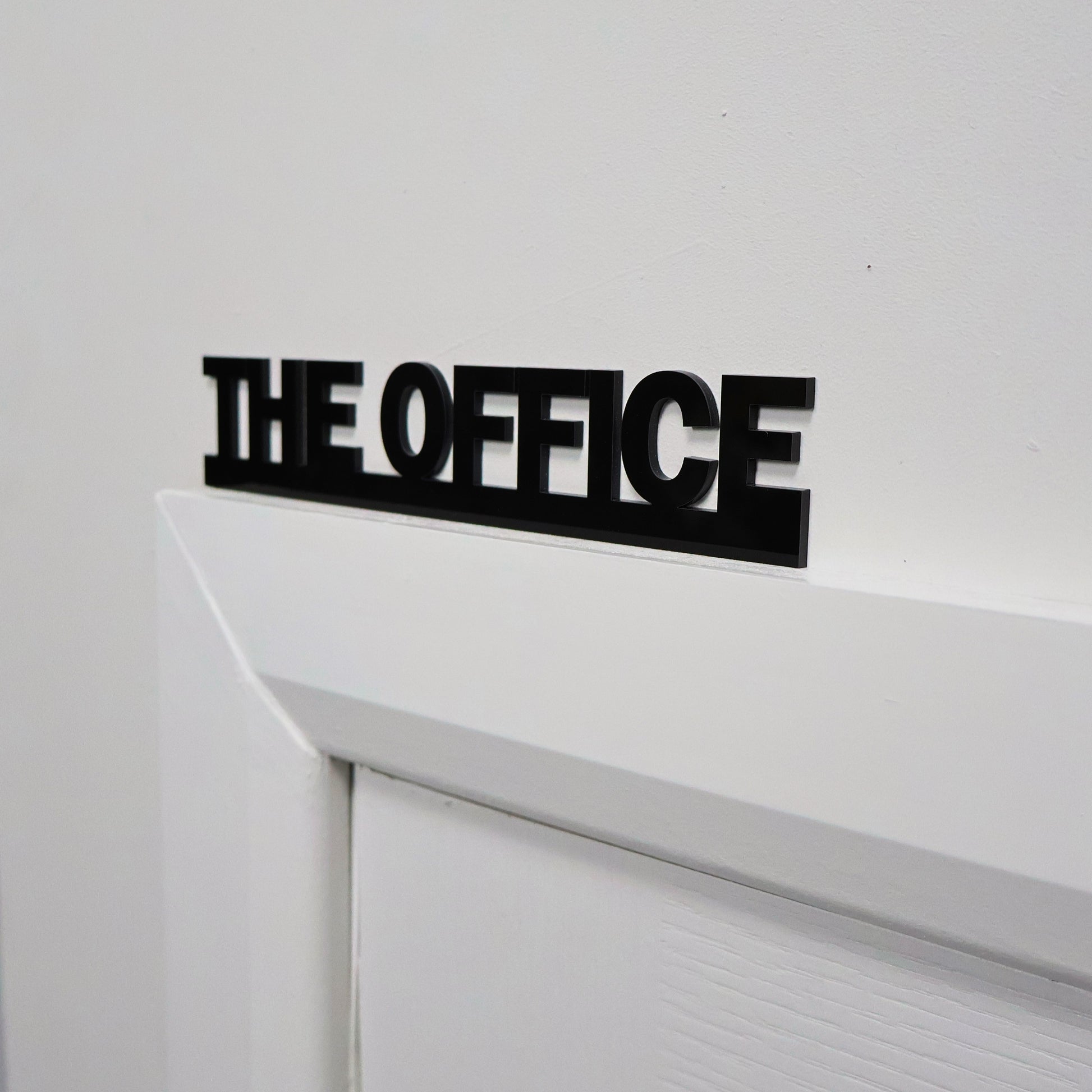 Modern office wall sign displayed above door frame – clean contemporary design