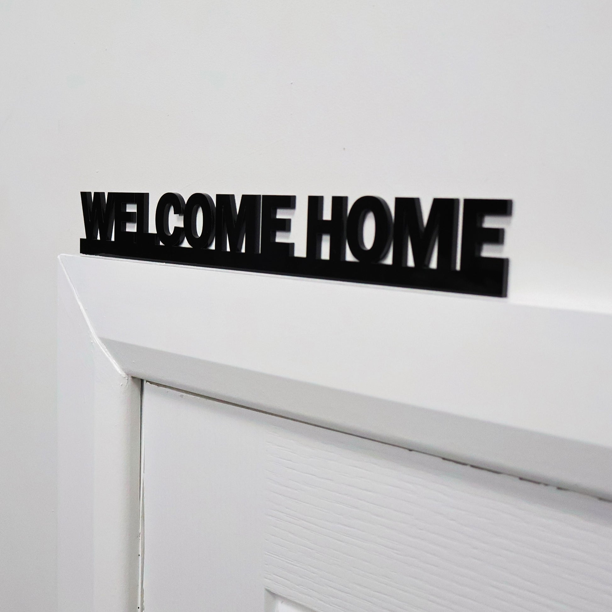 WELCOME HOME Door Topper displayed above standard white door frame