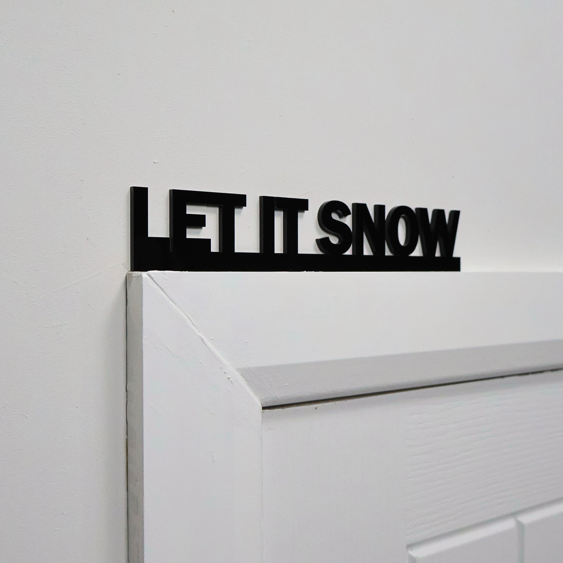 Handmade black acrylic Christmas wall sign made in the UK