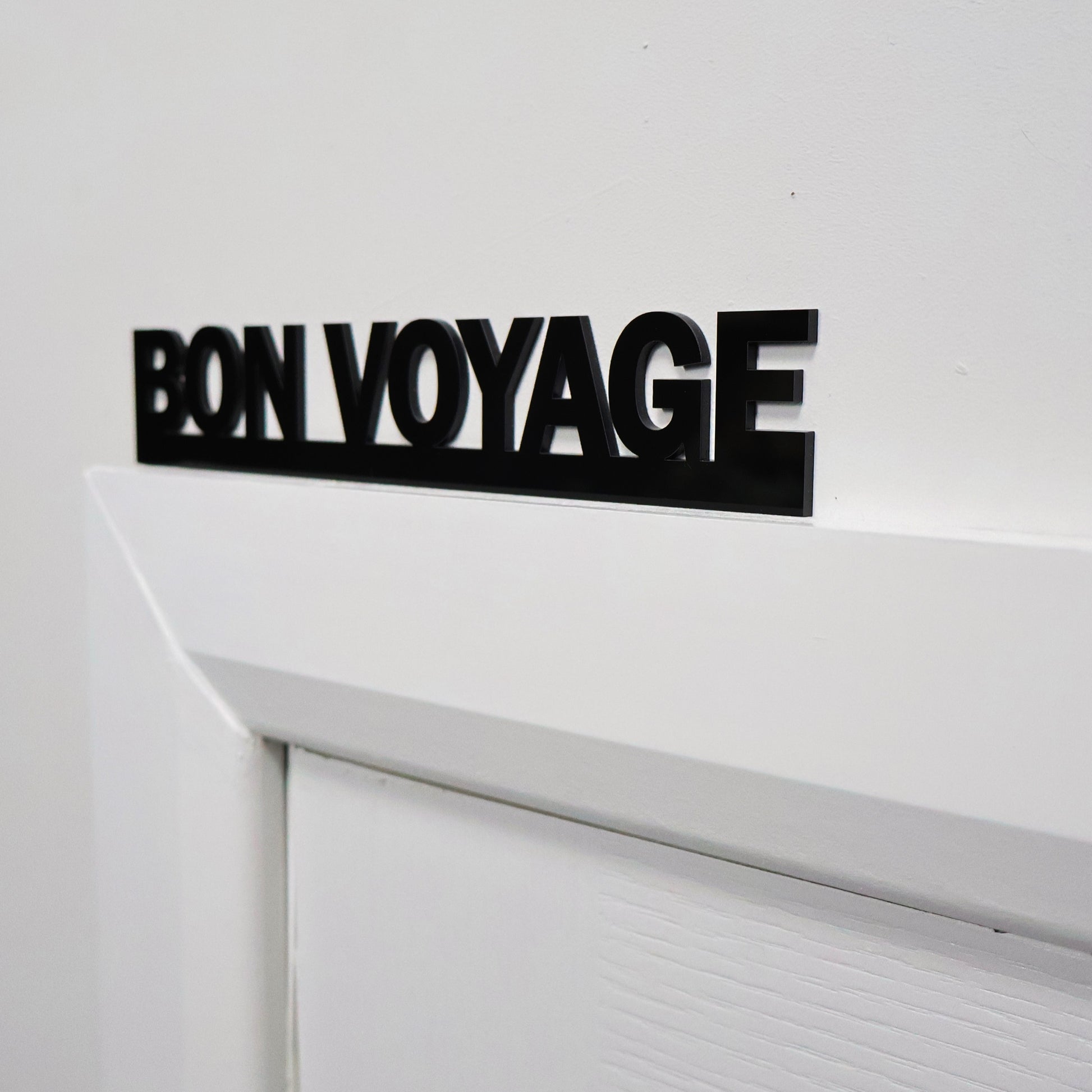 Farewell wall sign above a door frame – sleek and stylish home decor detail