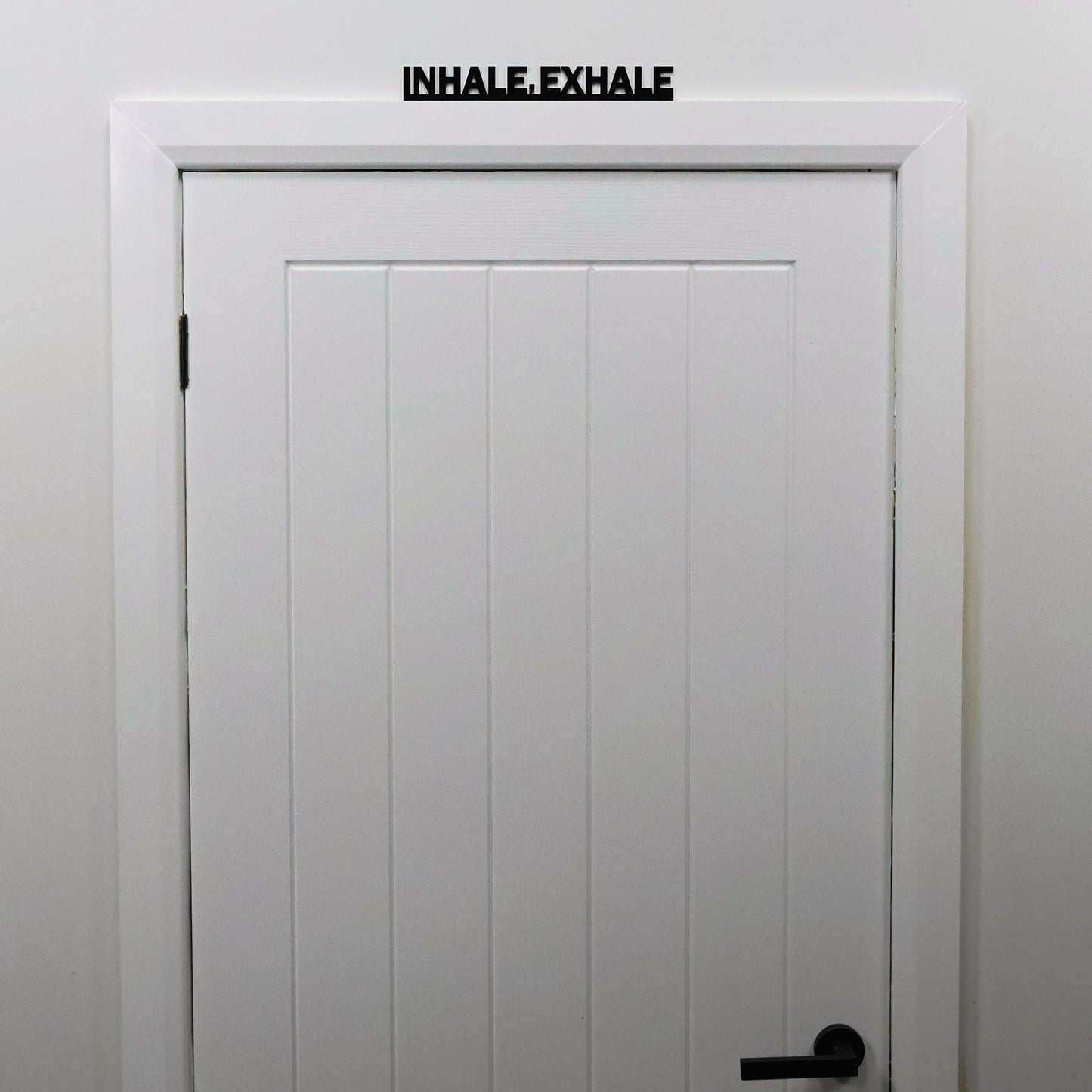Interior styling with INHALE EXHALE Door Topper displayed in studio