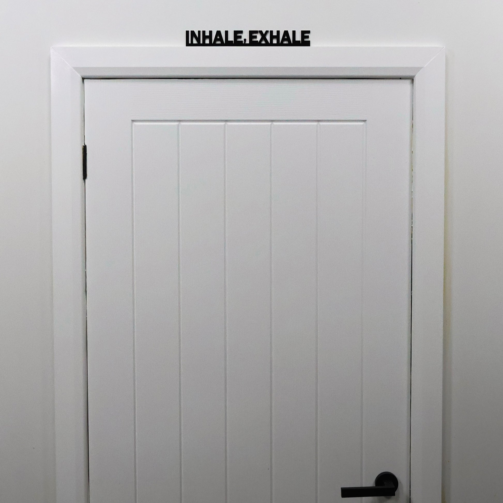 Interior styling with INHALE EXHALE Door Topper displayed in studio