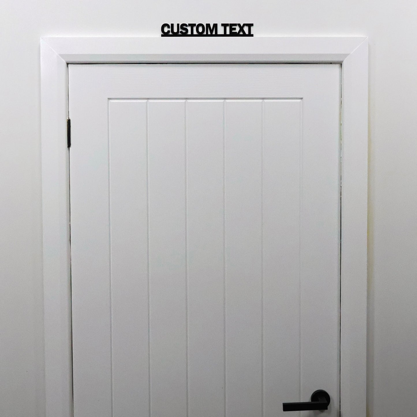 Bespoke personalised sign displayed above a doorway – black acrylic wall art handmade in the UK, ideal housewarming or Christmas gift