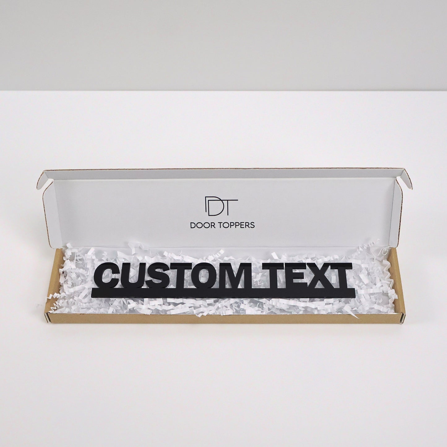 Gift packaging showing customised door topper neatly wrapped – handmade personalised sign ready to gift for birthdays, weddings or Christmas