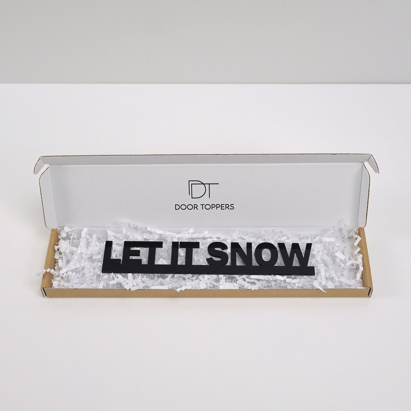 Eco friendly packaging for the LET IT SNOW Door Topper handmade in the UK