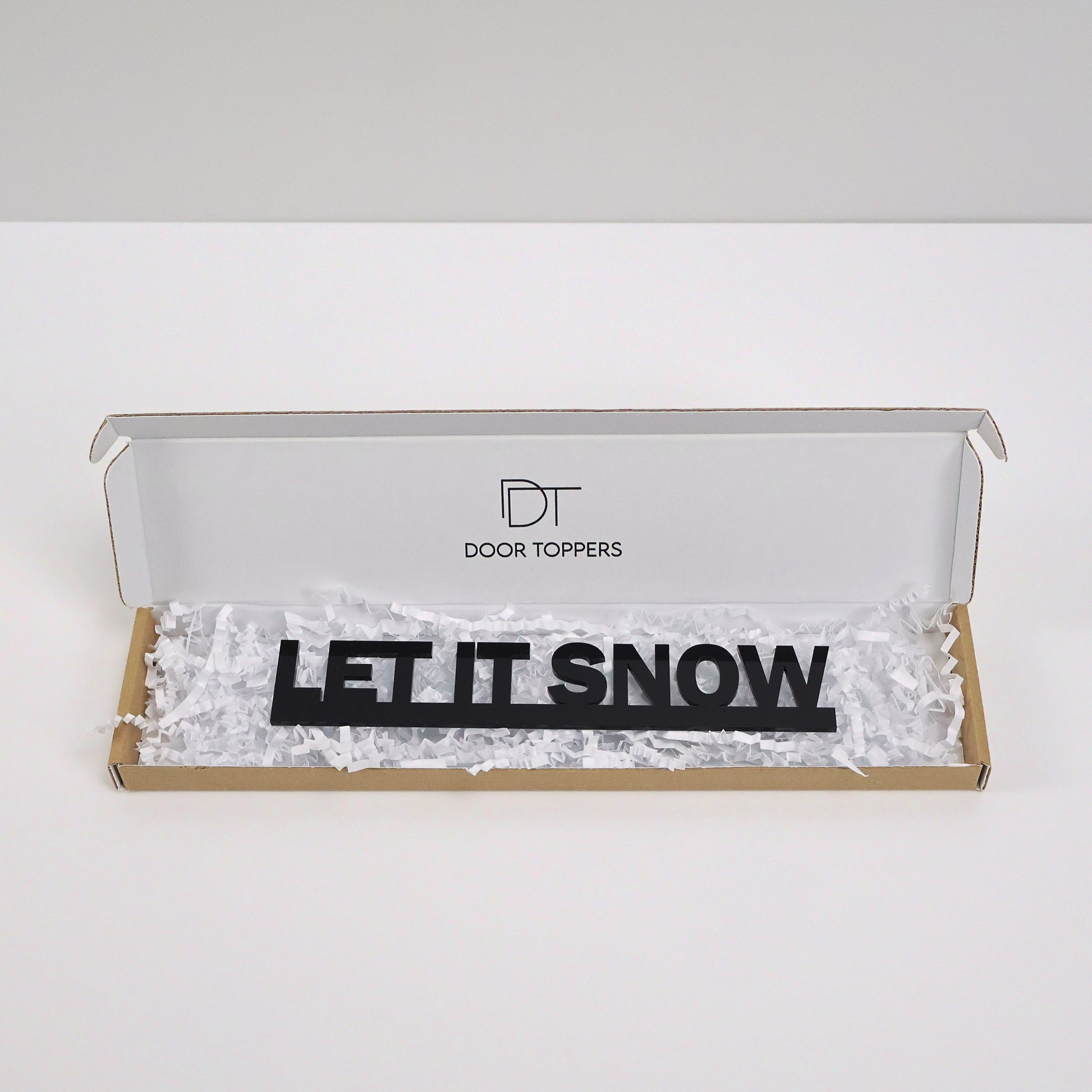 Eco friendly packaging for the LET IT SNOW Door Topper handmade in the UK