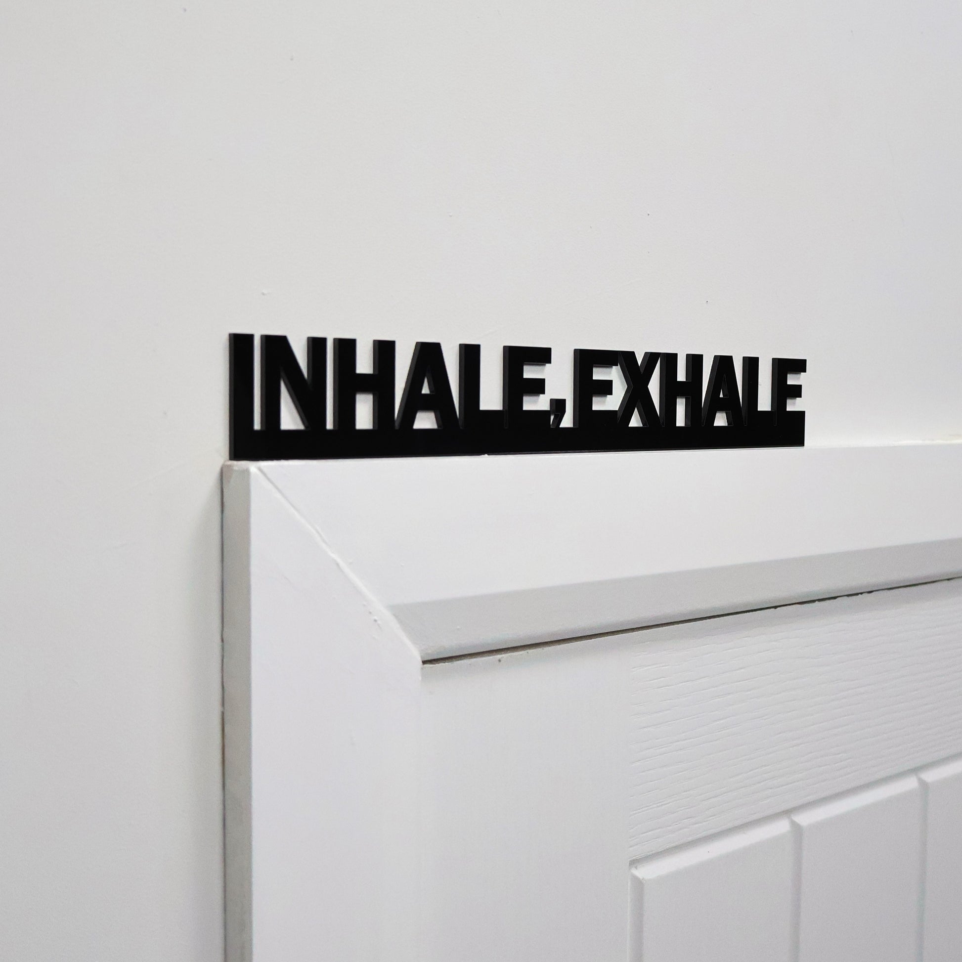 Close-up of smooth acrylic mindfulness sign mounted on wall surface