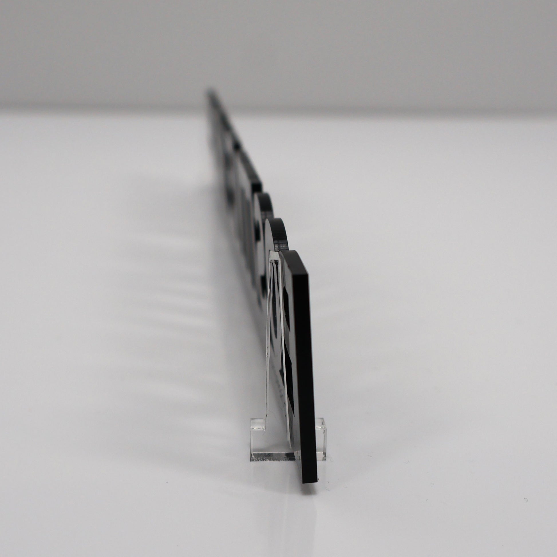 Clear acrylic stands shown for shelf or desk display