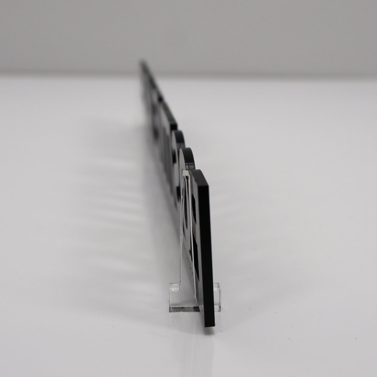 Freestanding display of the Door Topper on a wooden console table using clear acrylic stands.