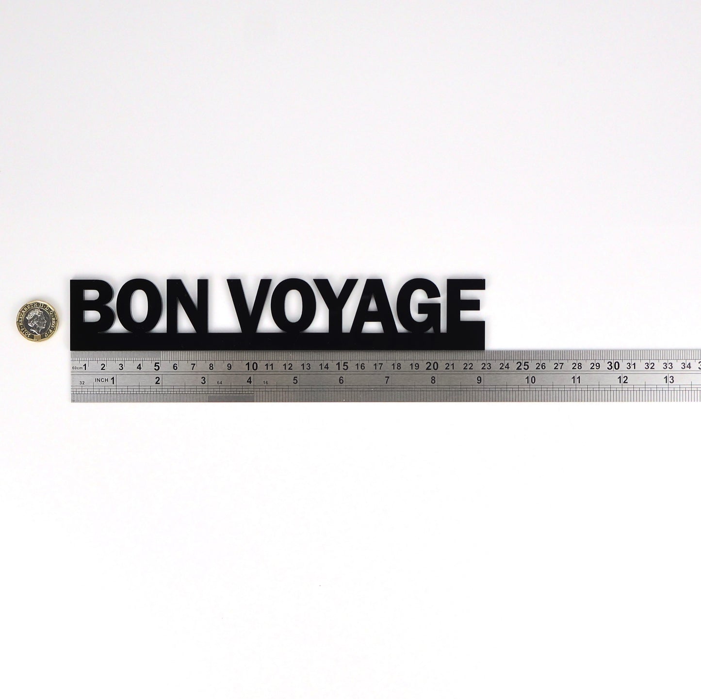 Product size image showing the BON VOYAGE sign beside a ruler and pound coin.