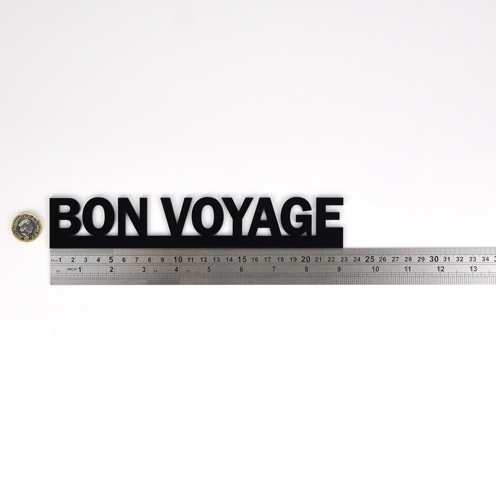 Product size image showing the BON VOYAGE sign beside a ruler and pound coin.