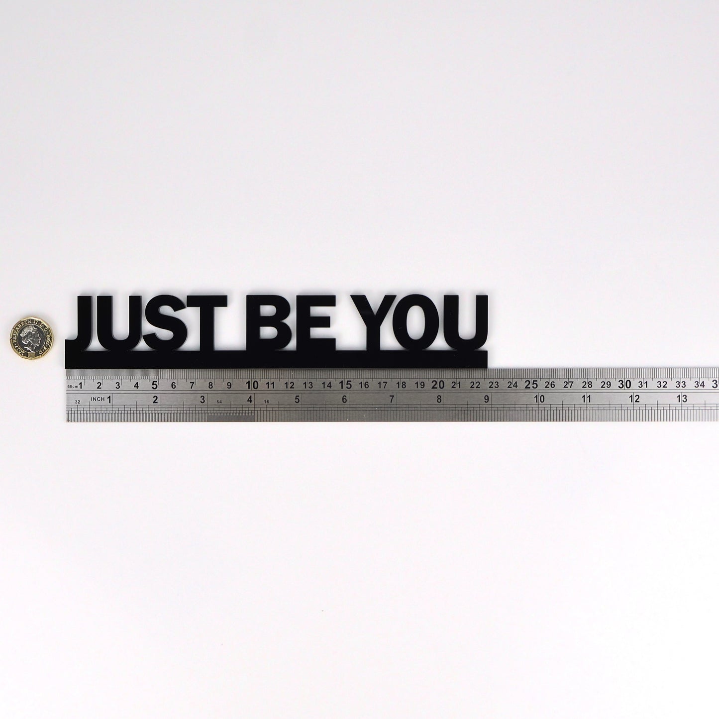 Size reference – sign beside ruler and pound coin