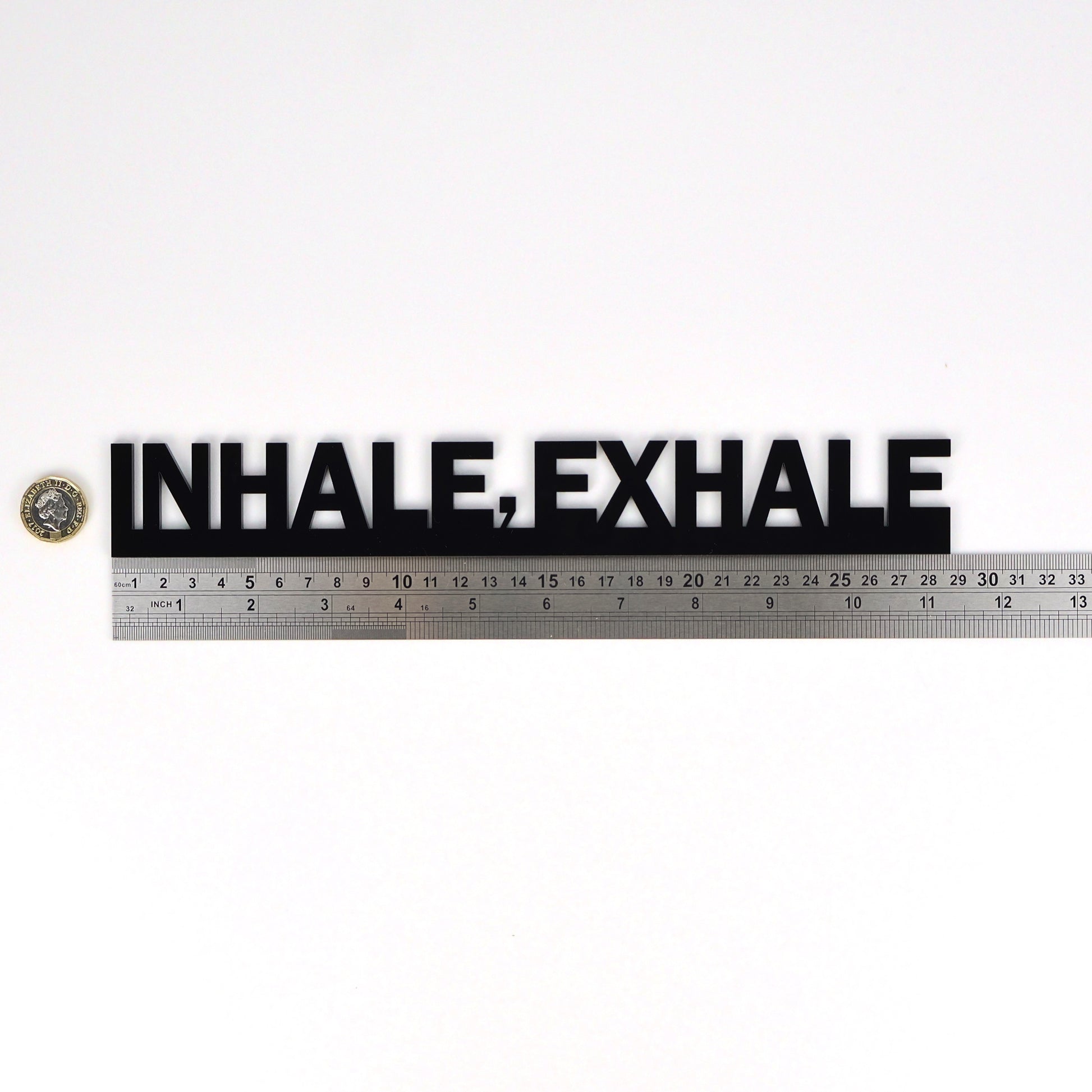 Mindfulness door topper placed beside ruler and pound coin for scale reference