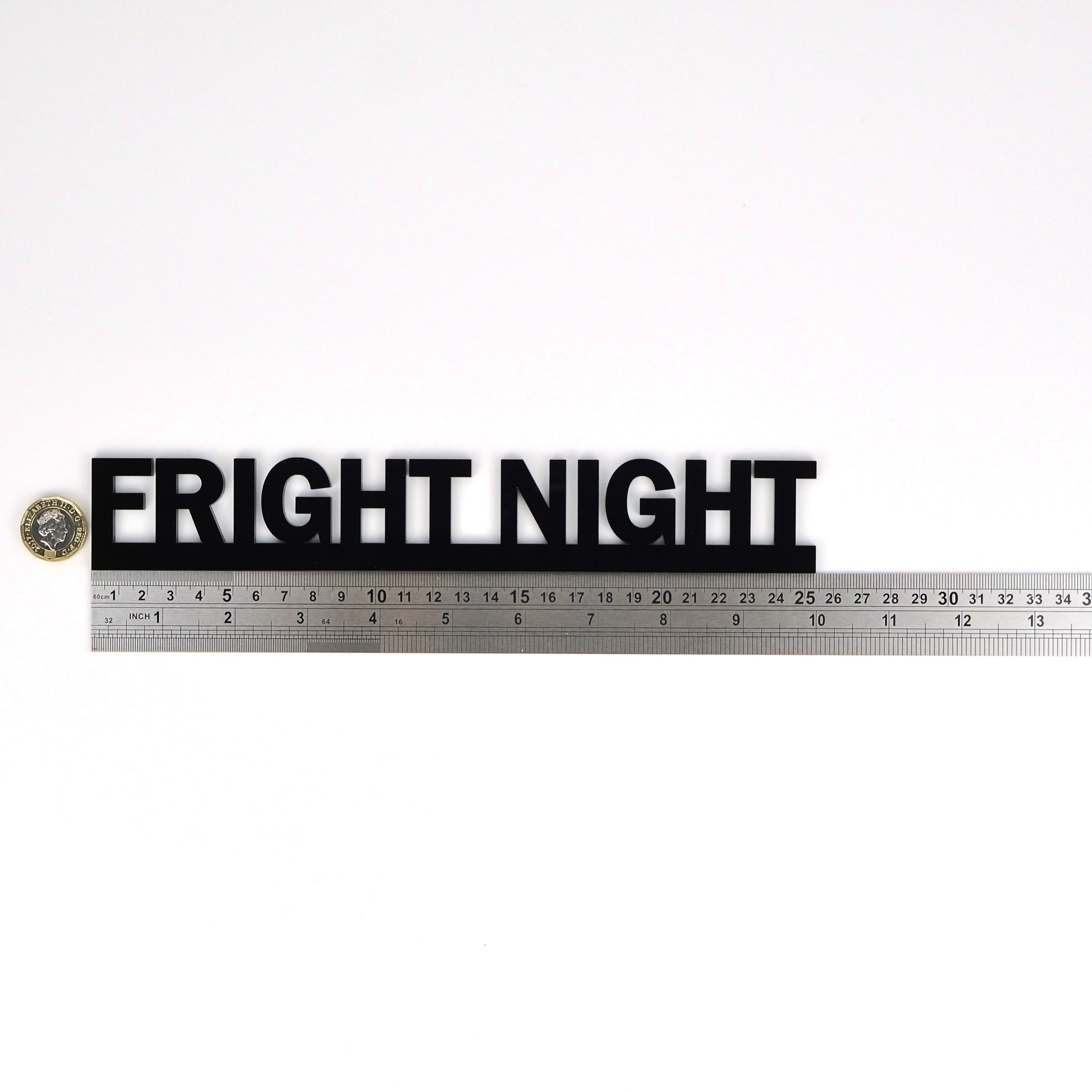 FRIGHT NIGHT wall sign beside a pound coin for size reference