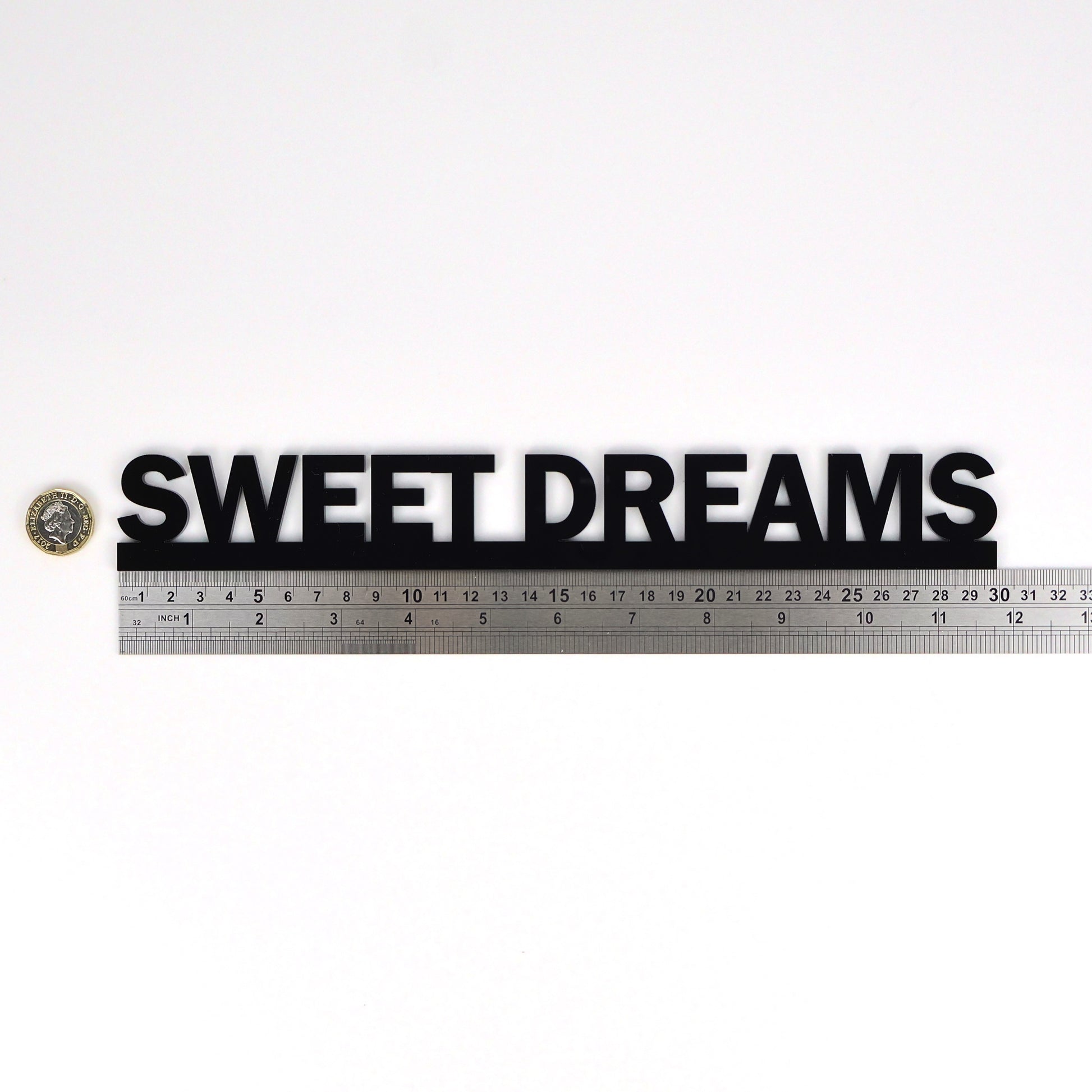 Size reference – sign beside ruler and pound coin