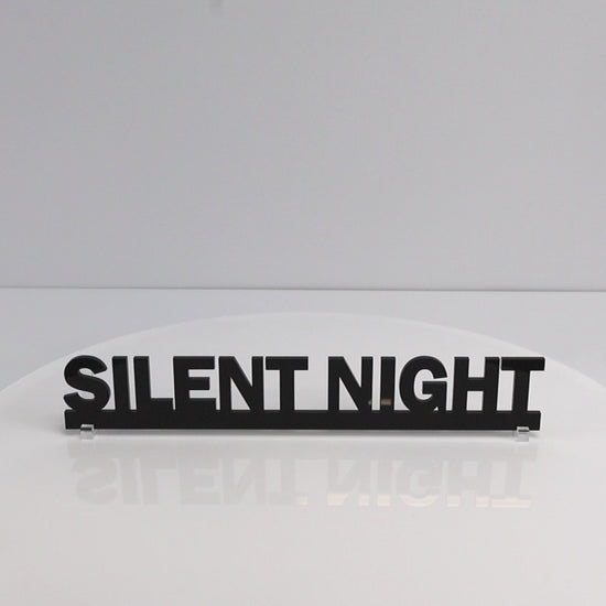 Close-up of glossy black acrylic lettering on SILENT NIGHT Christmas sign