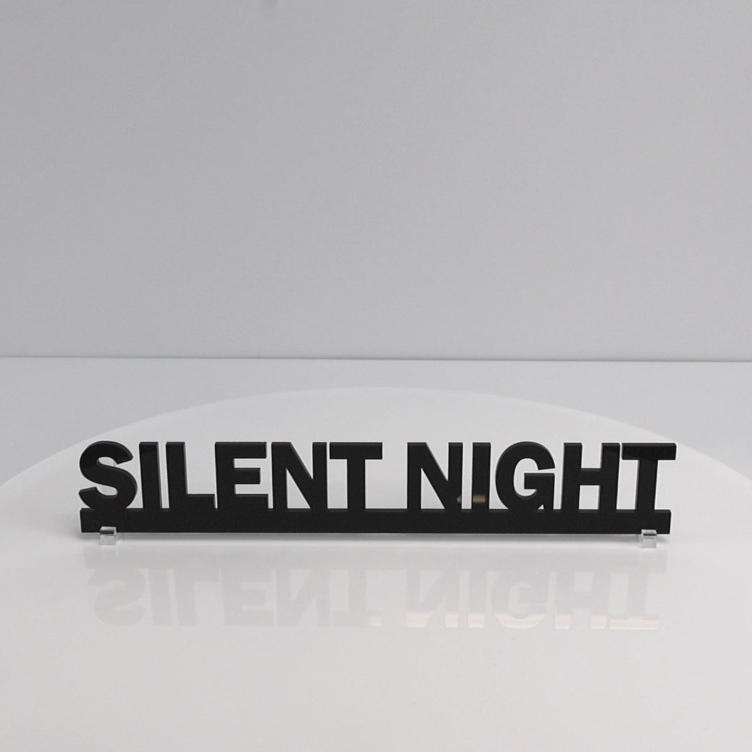 Close-up of glossy black acrylic lettering on SILENT NIGHT Christmas sign