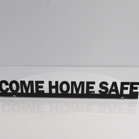 Rotating close-up video of COME HOME SAFE acrylic sign highlighting shine and thickness