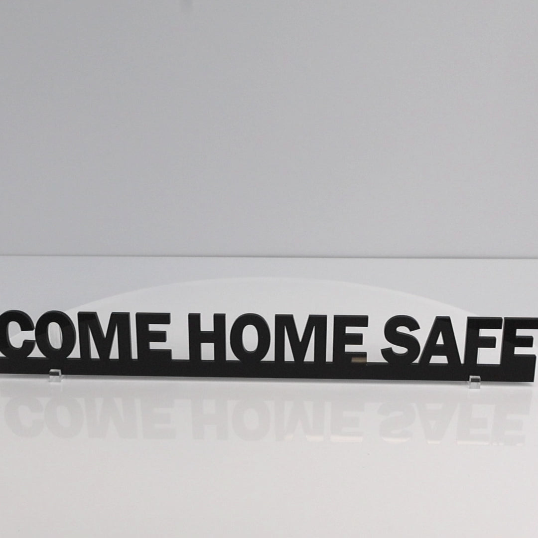 Rotating close-up video of COME HOME SAFE acrylic sign highlighting shine and thickness